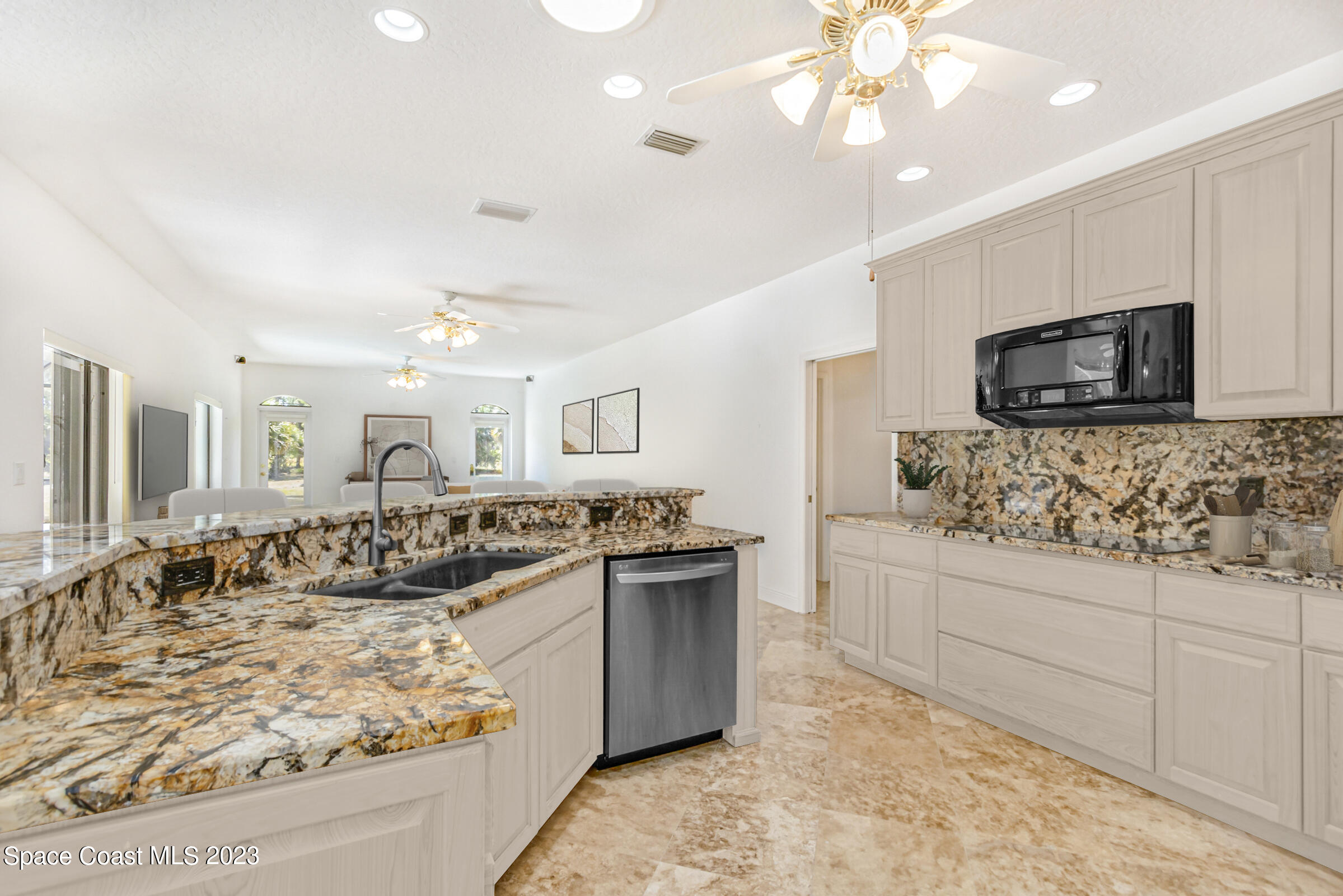 271 Deer Run Road Palm Bay, FL 32909 - Photo 5 of 61 a kitchen with stainless steel appliances granite countertop a sink and a stove