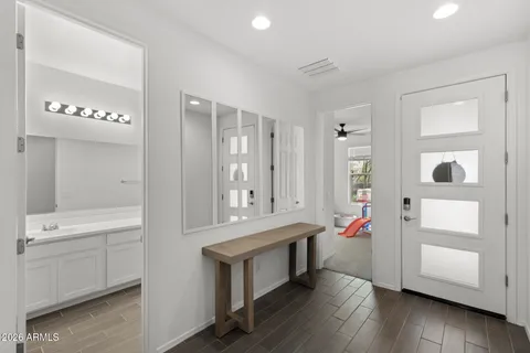 a bathroom with a tub sink and mirror