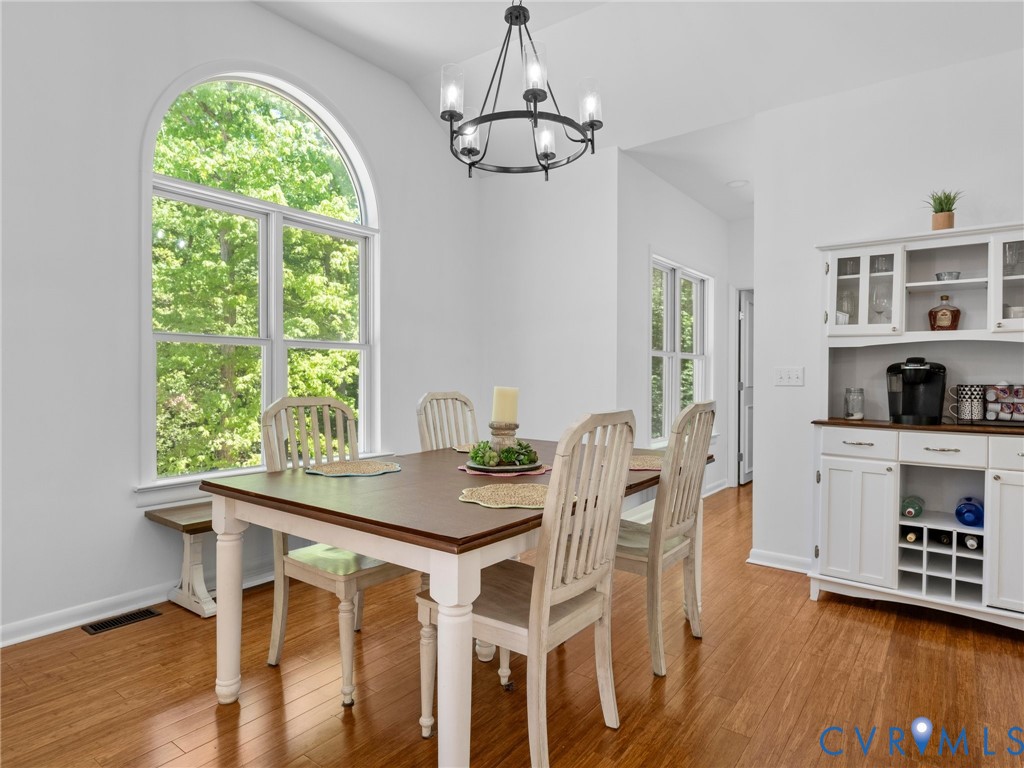 6126 Autumn Bluff Road Powhatan, VA 23139 - Photo 20 of 47 a view of a dining room with furniture window and wooden floor