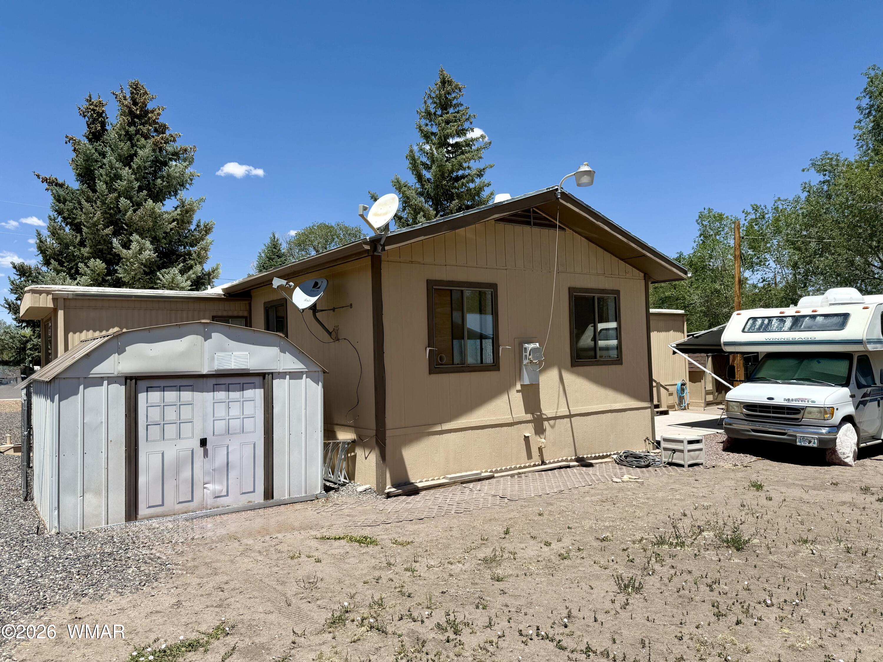 727 South Butler Street Eagar, AZ 85925 - Photo 28 of 32 a front view of a house with a garden