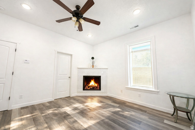 629 North 100 East Logan, UT 84321 - Photo 6 of 11 Living area featuring a corner fireplace with a white mosaic tile surround and mantel