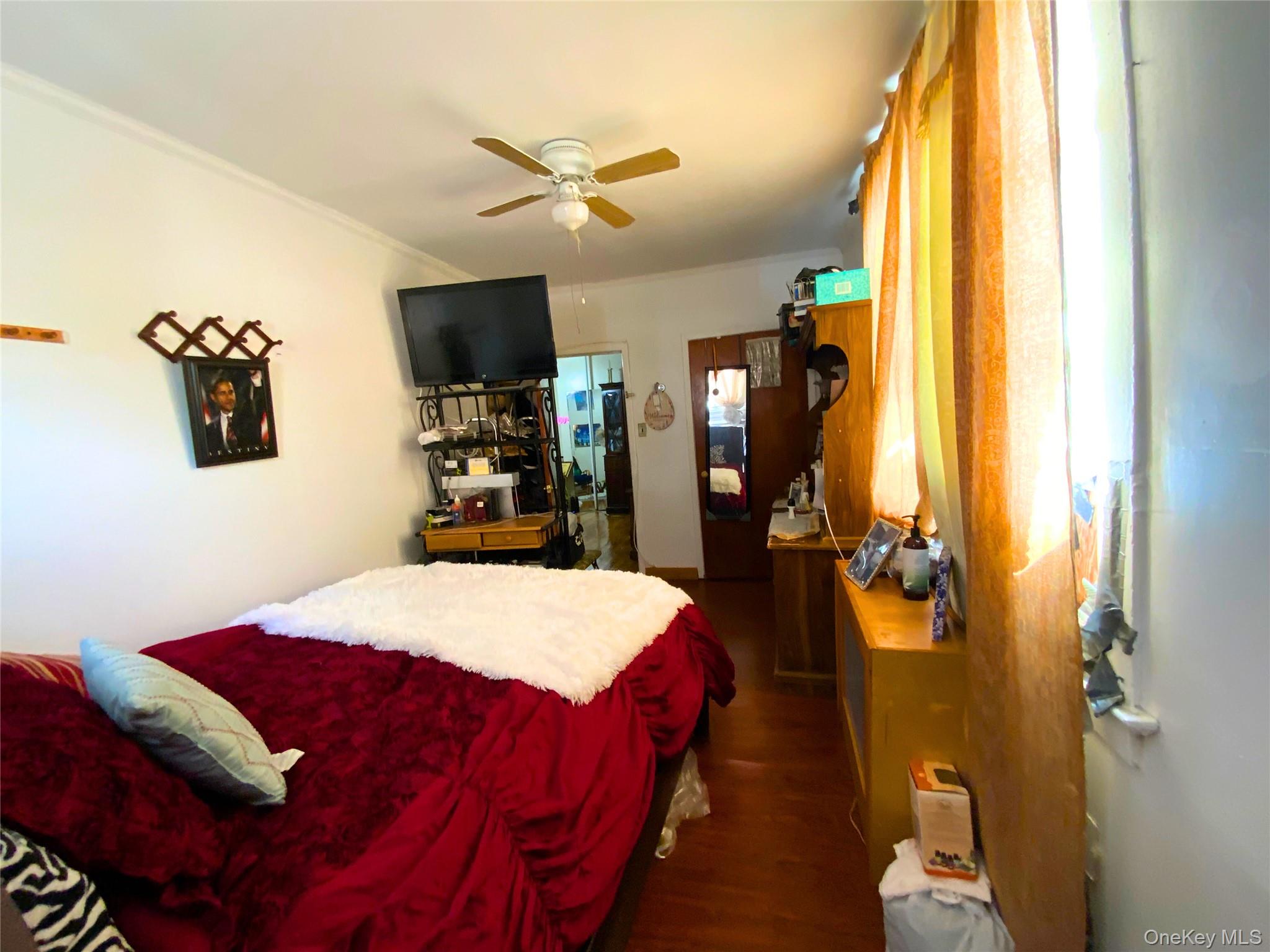 552 Beach 68th Street Queens, NY 11692 - Photo 12 of 34 a bedroom with a bed and a flat screen tv