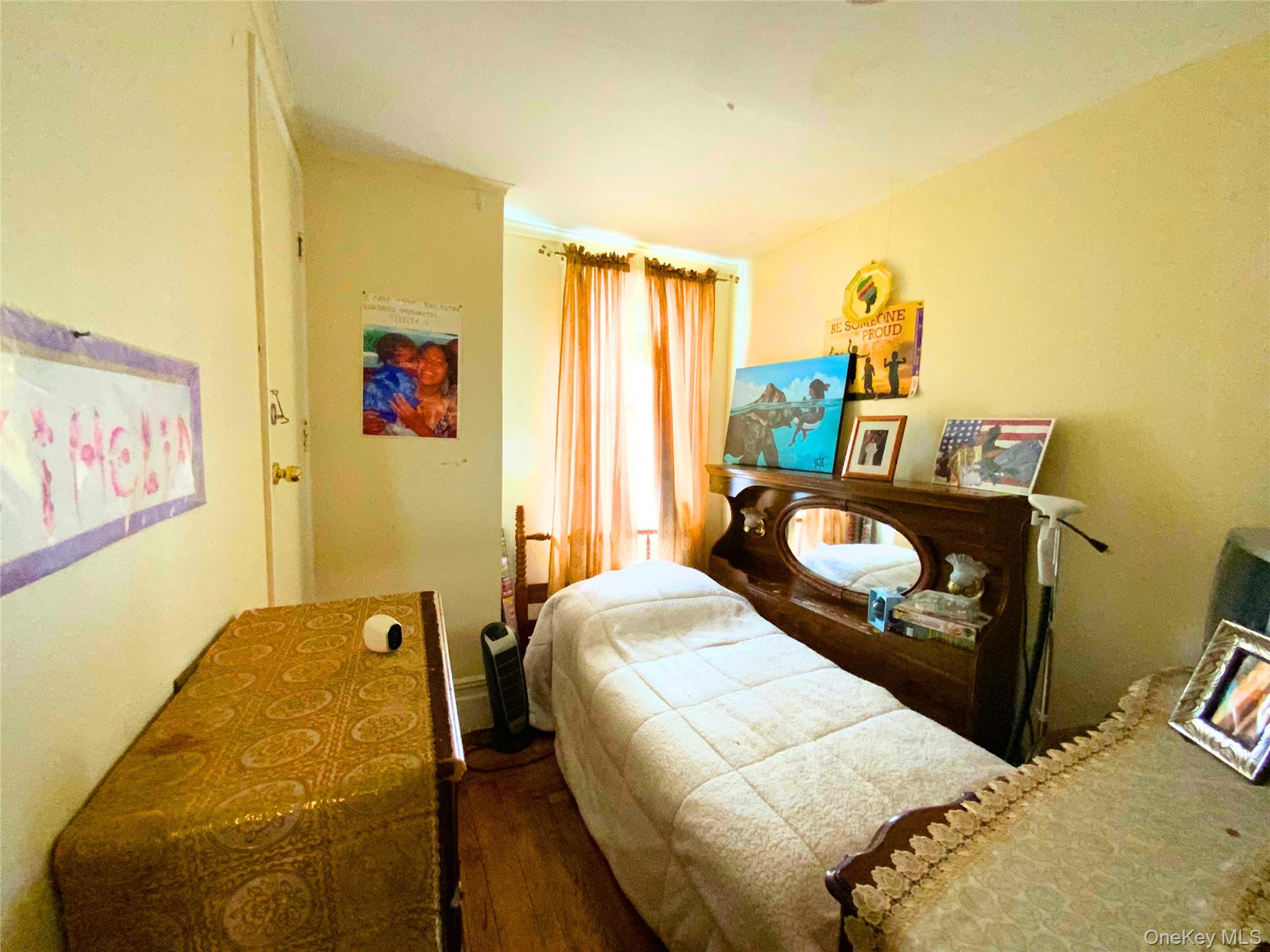 552 Beach 68th Street Queens, NY 11692 - Photo 17 of 34 a bedroom with a bed and a dresser