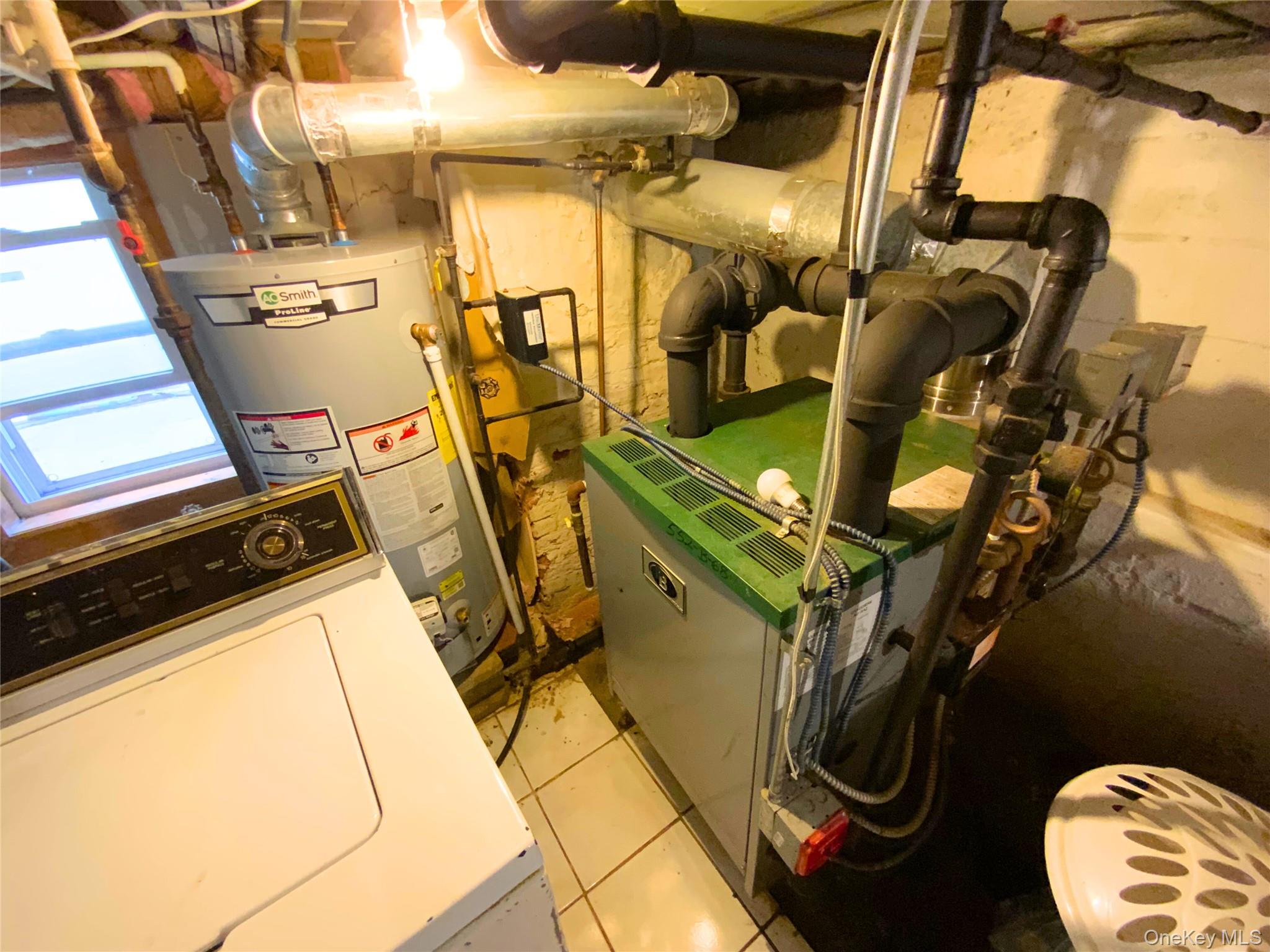 552 Beach 68th Street Queens, NY 11692 - Photo 20 of 34 a utility room with dryer washer and a view of the shower