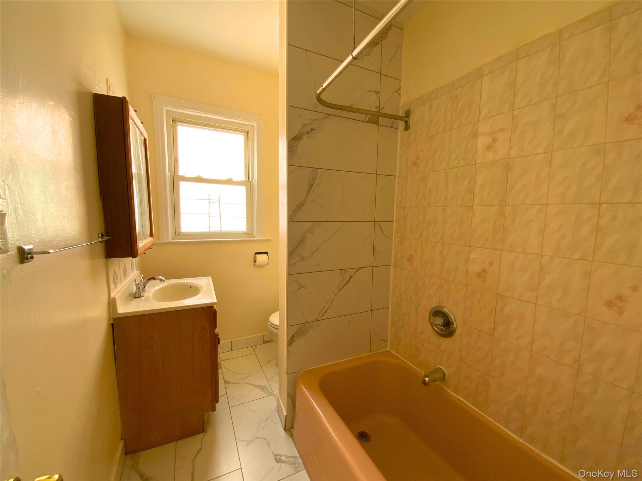 552 Beach 68th Street Queens, NY 11692 - Photo 27 of 34 a bathroom with a bathtub and shower