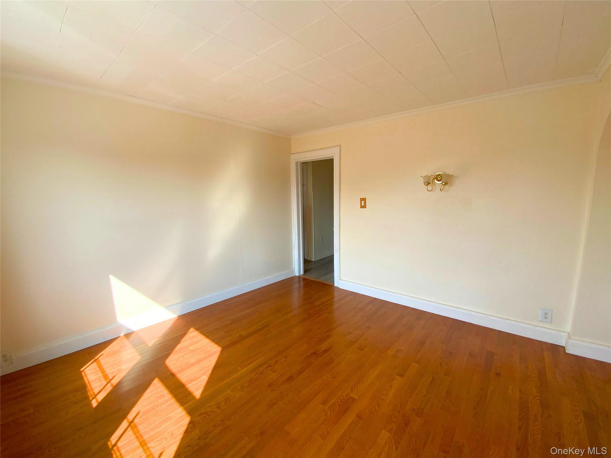 552 Beach 68th Street Queens, NY 11692 - Photo 28 of 34 a view of empty room with wooden floor