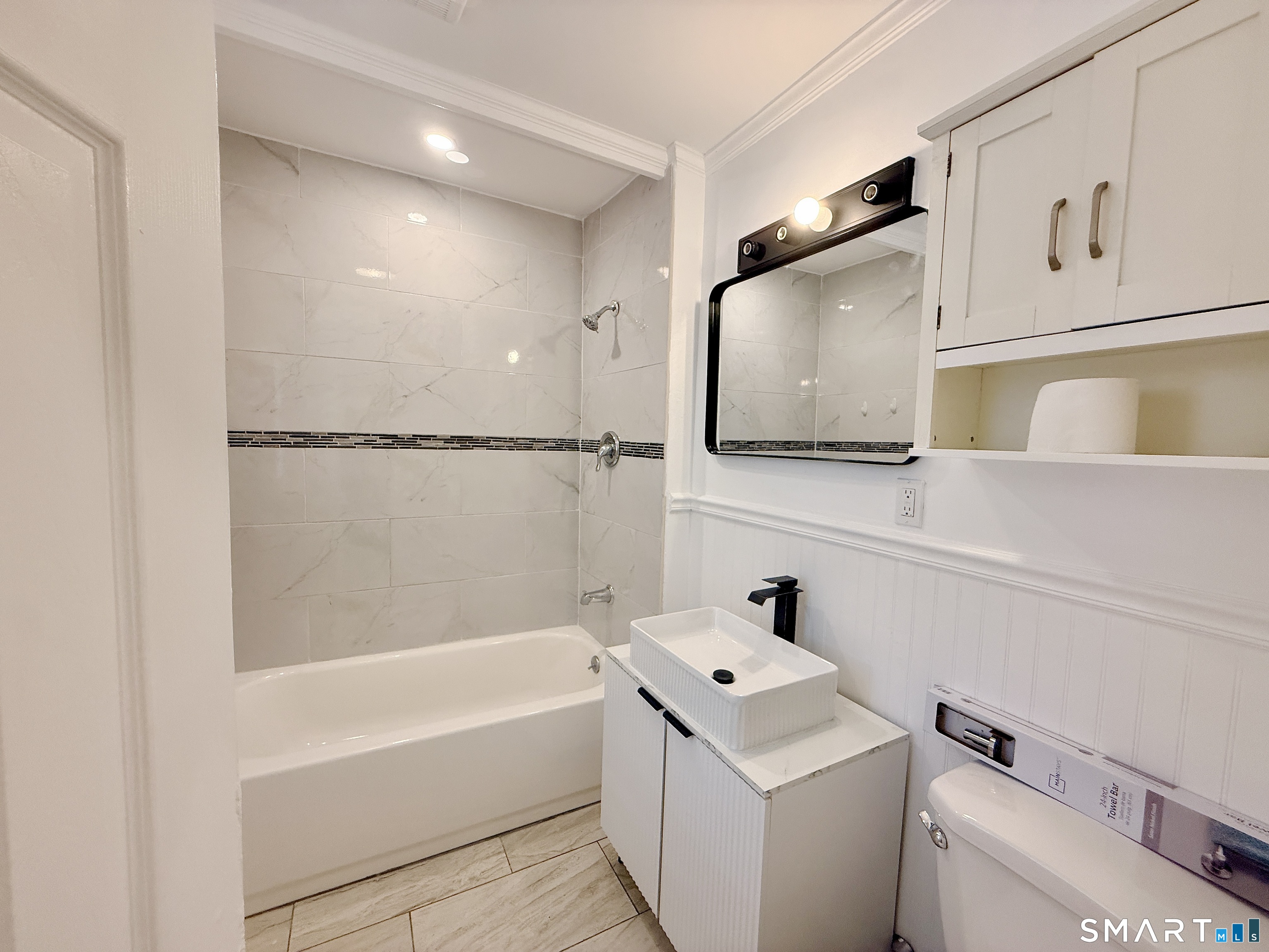 70 Lindley Street Bridgeport, CT 06604 - Photo 6 of 8 a bathroom with a sink a toilet and bathtub