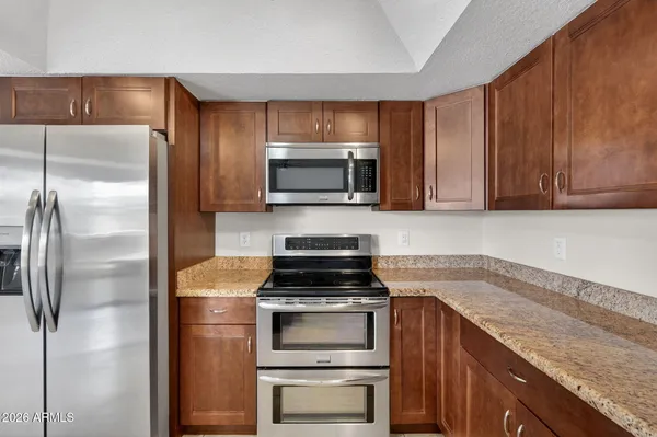 a kitchen with a refrigerator stove and microwave