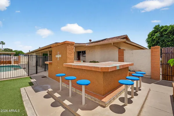 a backyard of a house with table and chairs