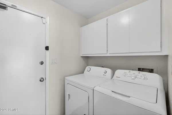a view of storage and utility room with washer and dryer