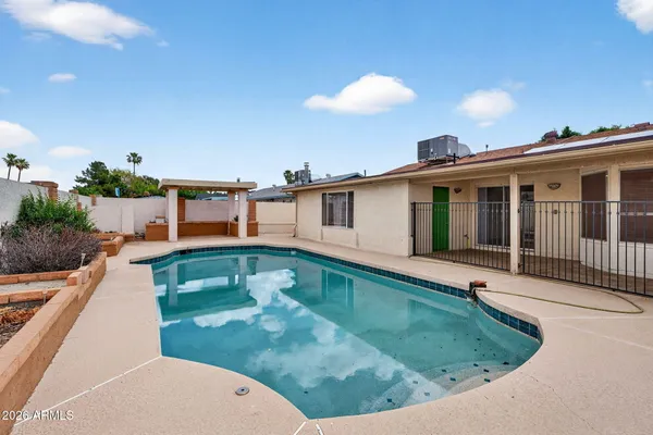 a view of a house with a backyard