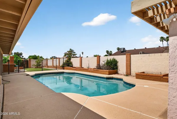 a view of a swimming pool and an outdoor seating