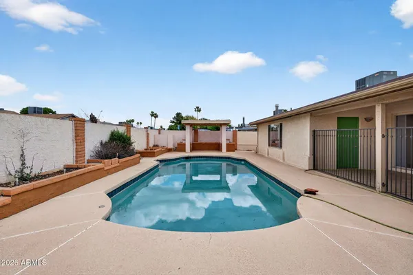 a swimming pool with outdoor seating and yard