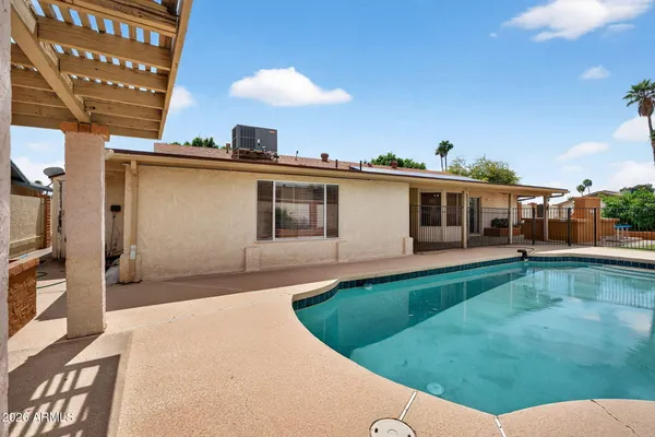 a view of a house with a backyard and porch