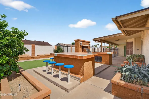 a view of a house with backyard porch and furniture