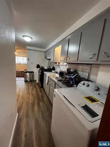 a kitchen that has a lot of cabinets a sink and a stove in it
