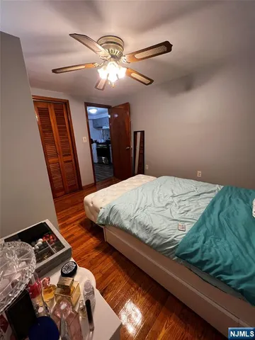 a bedroom with a bed and a mirror on dresser