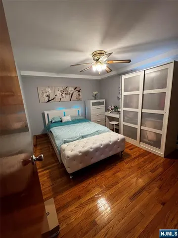 a bedroom with a bed closet and a chair