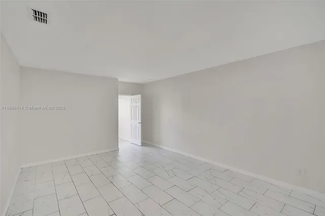 a view of kitchen with white cabinets and sink