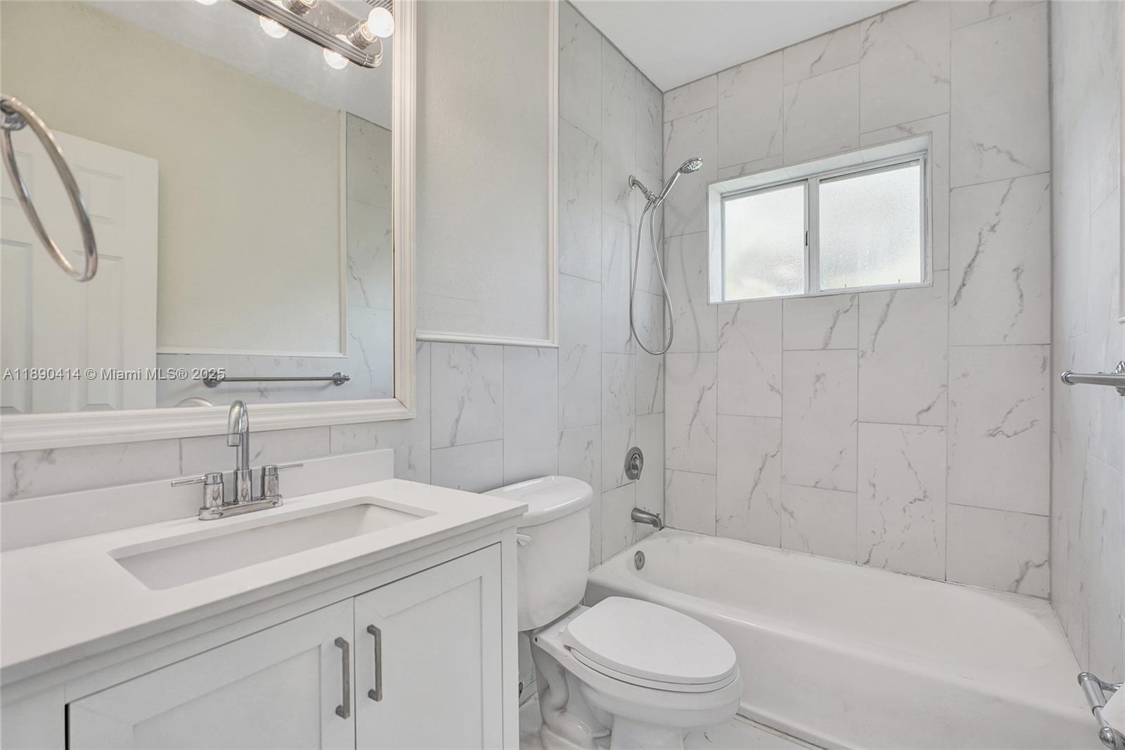 1945 Calais Drive, Unit 9 Miami Beach, FL 33141 - Photo 23 of 47 a bathroom with a sink toilet a vanity and bathtub
