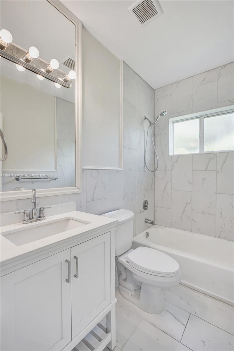 1945 Calais Drive, Unit 9 Miami Beach, FL 33141 - Photo 24 of 47 a bathroom with a sink a toilet and shower