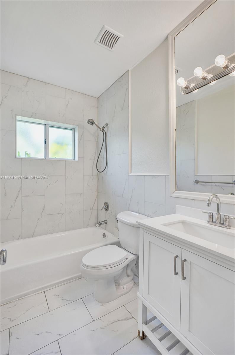 1945 Calais Drive, Unit 9 Miami Beach, FL 33141 - Photo 25 of 47 a bathroom with a sink a toilet and shower