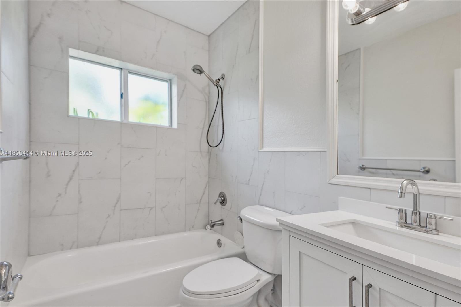 1945 Calais Drive, Unit 9 Miami Beach, FL 33141 - Photo 26 of 47 a bathroom with a sink toilet vanity and shower