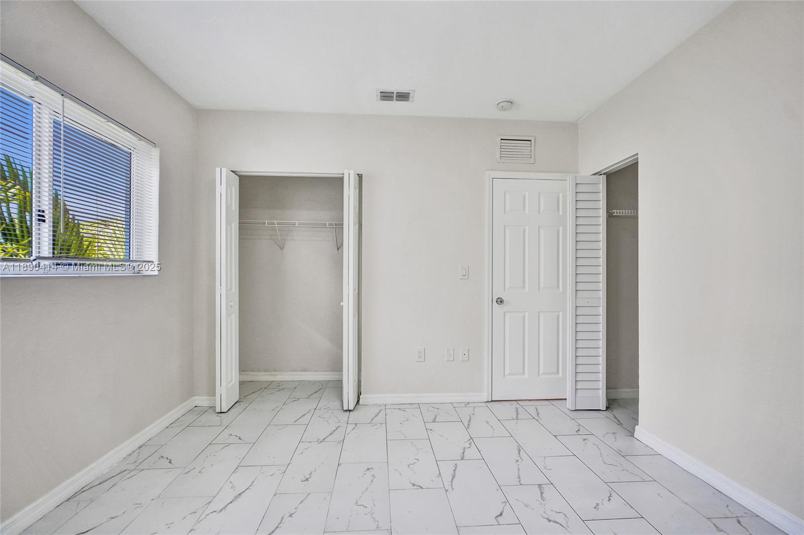 1945 Calais Drive, Unit 9 Miami Beach, FL 33141 - Photo 32 of 47 an empty room with windows