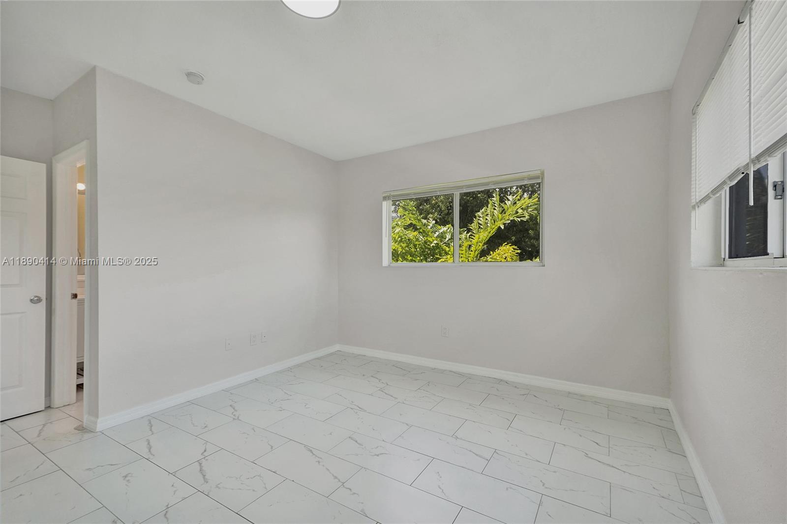 1945 Calais Drive, Unit 9 Miami Beach, FL 33141 - Photo 45 of 47 an empty room with windows
