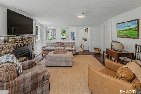 a living room with lots of furniture and kitchen view