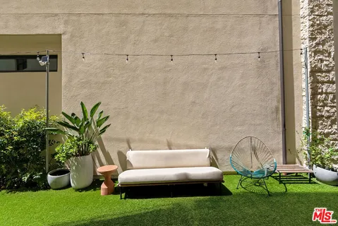 a living room with furniture and garden view