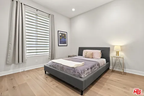 a living room with a couch and a wooden floor