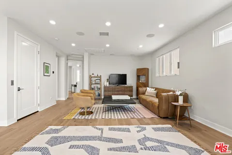 a living room with furniture and a floor to ceiling window