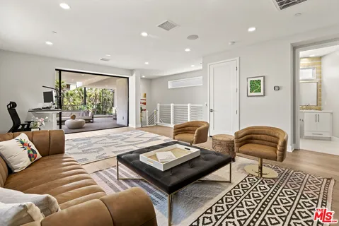 a living room with furniture and a floor to ceiling window