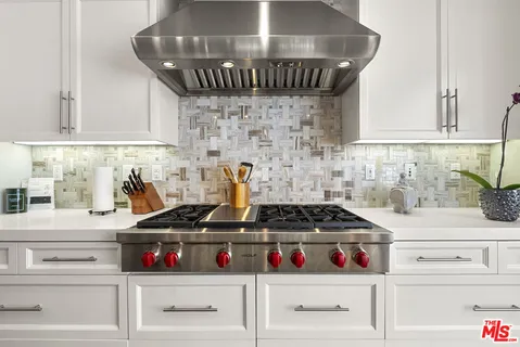 a kitchen with a stove and cabinets