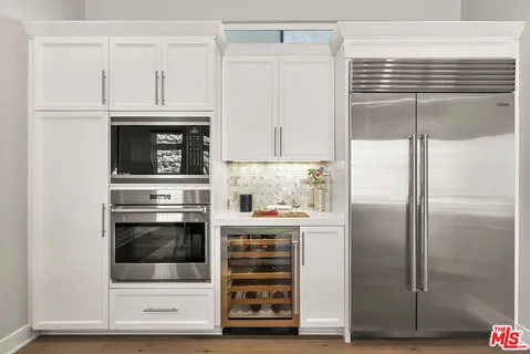 a kitchen with granite countertop a refrigerator and a stove
