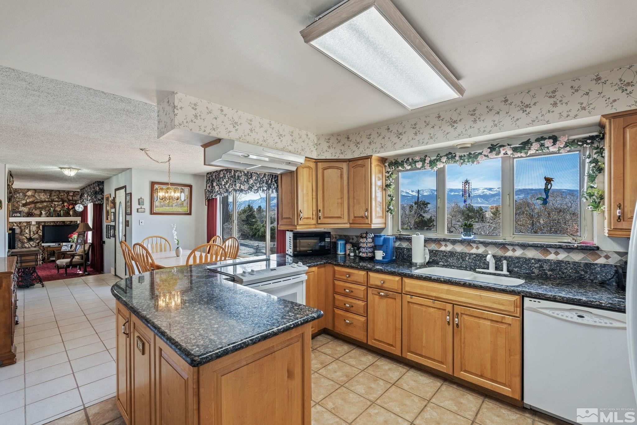 14440 Rim Rock Drive Reno, NV 89521 - Photo 11 of 39 a kitchen with stainless steel appliances granite countertop a sink and cabinets