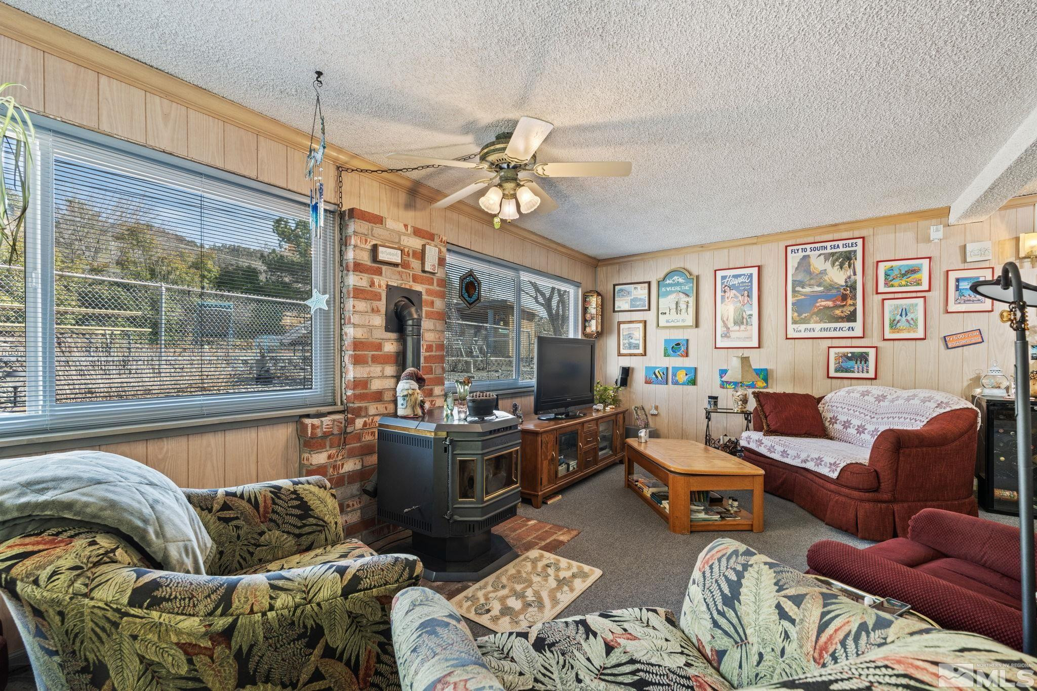 14440 Rim Rock Drive Reno, NV 89521 - Photo 15 of 39 a living room with furniture ceiling fan and a window