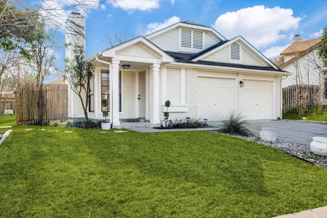 a front view of a house with garden