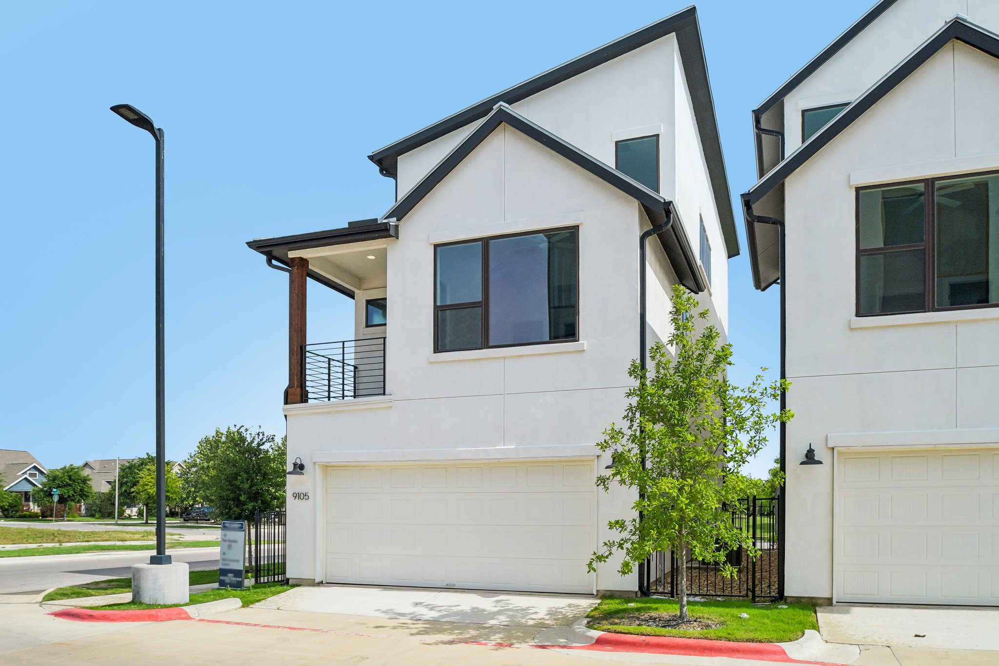 9105 Cattle Baron Path Austin, TX 78747 - Photo 28 of 31 Clean lines and modern design define the captivating street presence of this white stucco home.