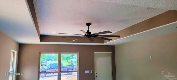 a living room with furniture and a painting on the wall