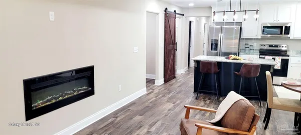 a kitchen with stainless steel appliances granite countertop a sink and a stove