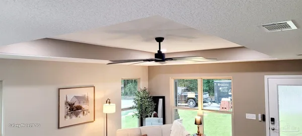 a view of a room with wooden floor and a window