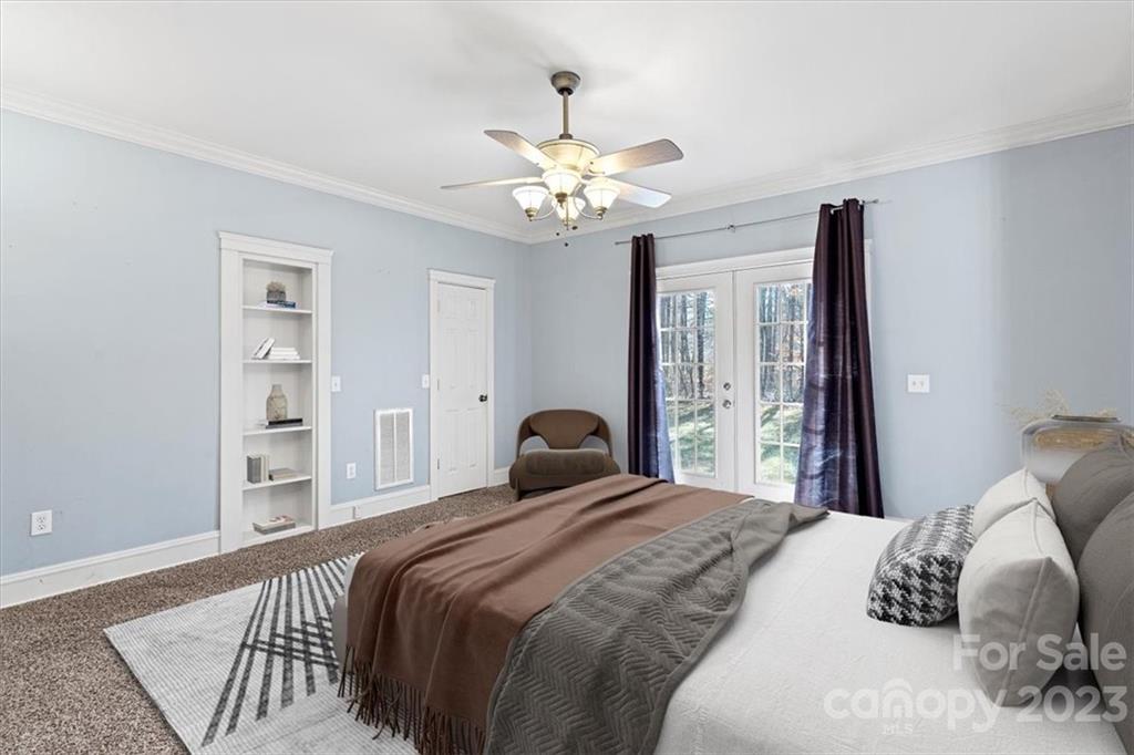 7275 Davidson Highway Concord, NC 28027 - Photo 14 of 47 a bedroom with a bed and a chandelier