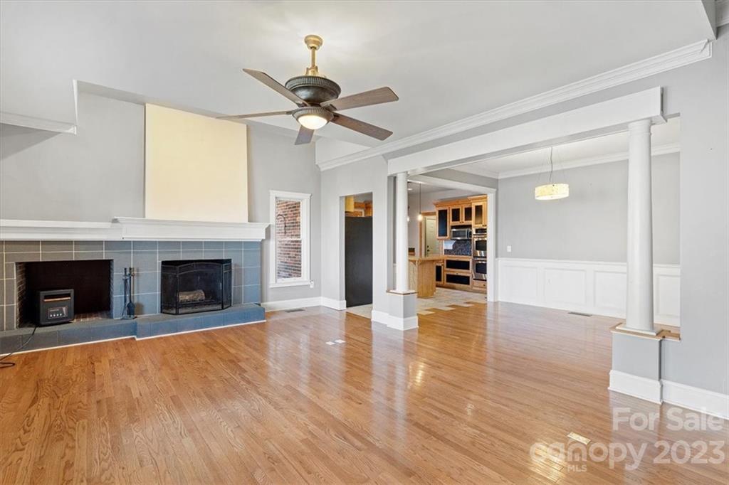 7275 Davidson Highway Concord, NC 28027 - Photo 3 of 47 a view of a livingroom with wooden floor a fireplace and window