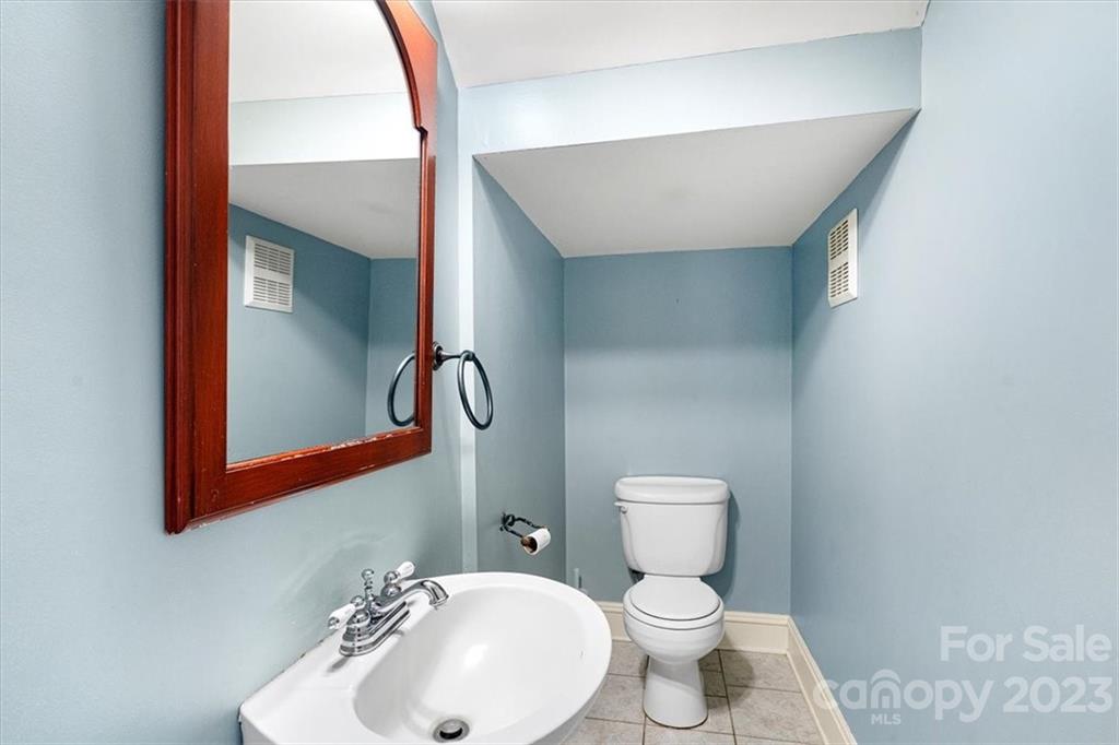 7275 Davidson Highway Concord, NC 28027 - Photo 31 of 47 a bathroom with a toilet sink and mirror