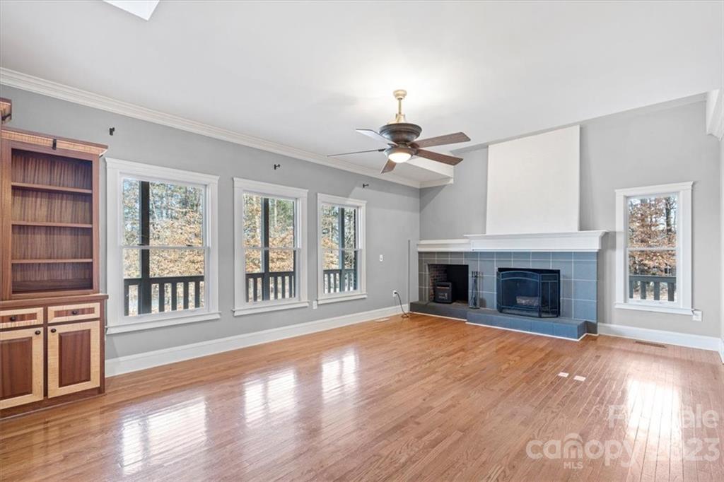 7275 Davidson Highway Concord, NC 28027 - Photo 38 of 47 a view of an empty room with wooden floor fireplace and a window
