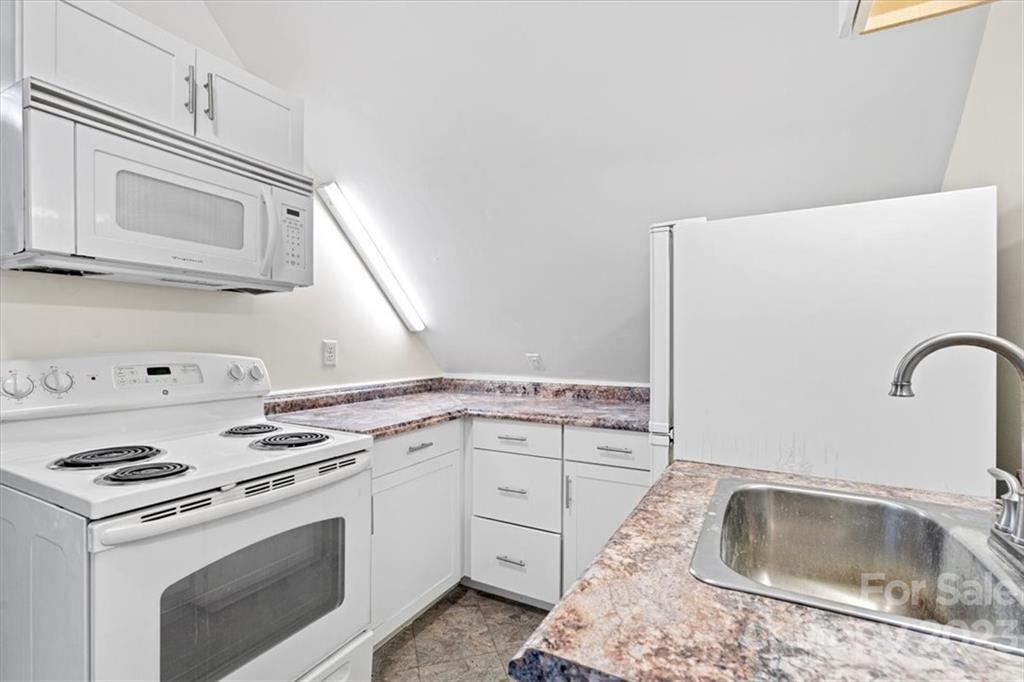 7275 Davidson Highway Concord, NC 28027 - Photo 39 of 47 a kitchen with granite countertop a sink stove and cabinets
