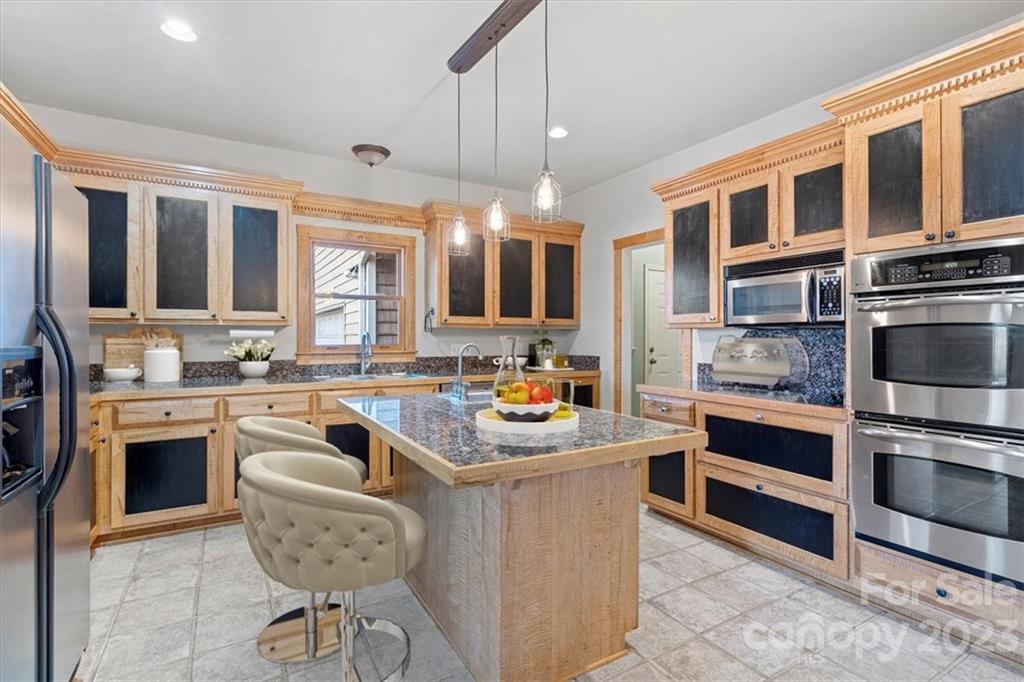 7275 Davidson Highway Concord, NC 28027 - Photo 6 of 47 a kitchen with stainless steel appliances granite countertop a stove and cabinets