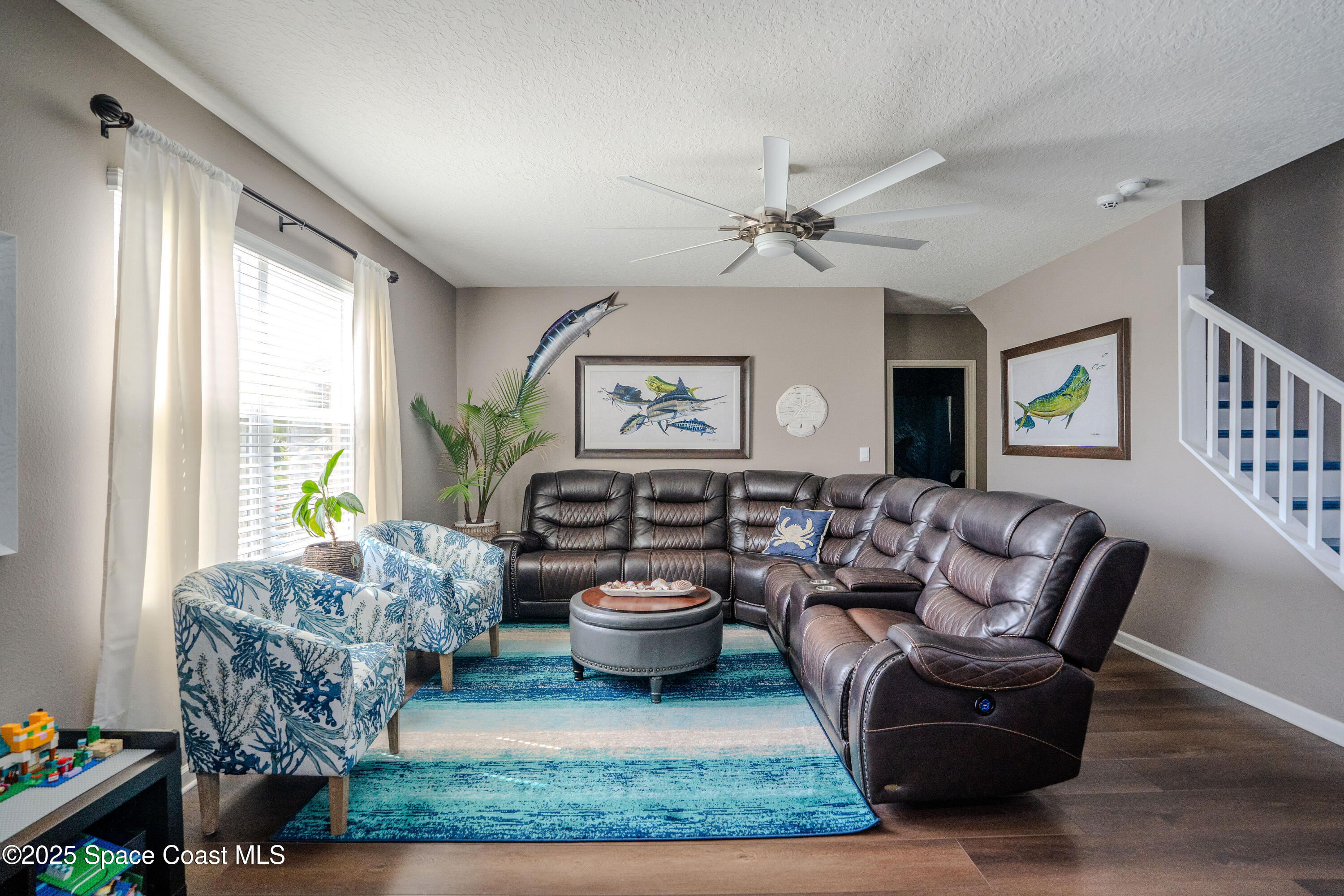 3409 Burrowing Owl Mims, FL 32754 - Photo 15 of 36 a living room with furniture and a large window